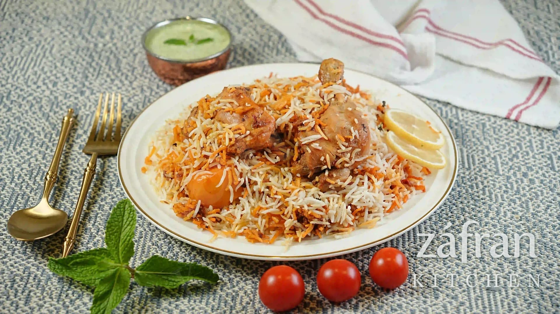 Plate of chicken biryani with raita at Zafran Kitchen, Ajman Industrial Area 2