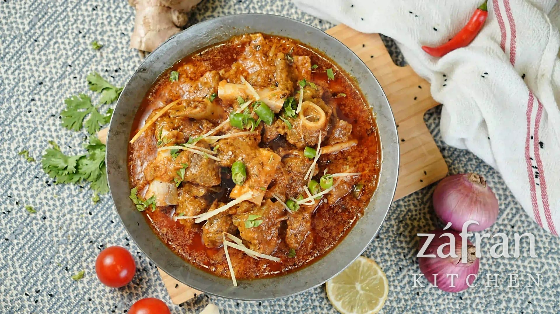 Karahi cooking over an open flame in the kitchen at Zafran Kitchen, Ajman